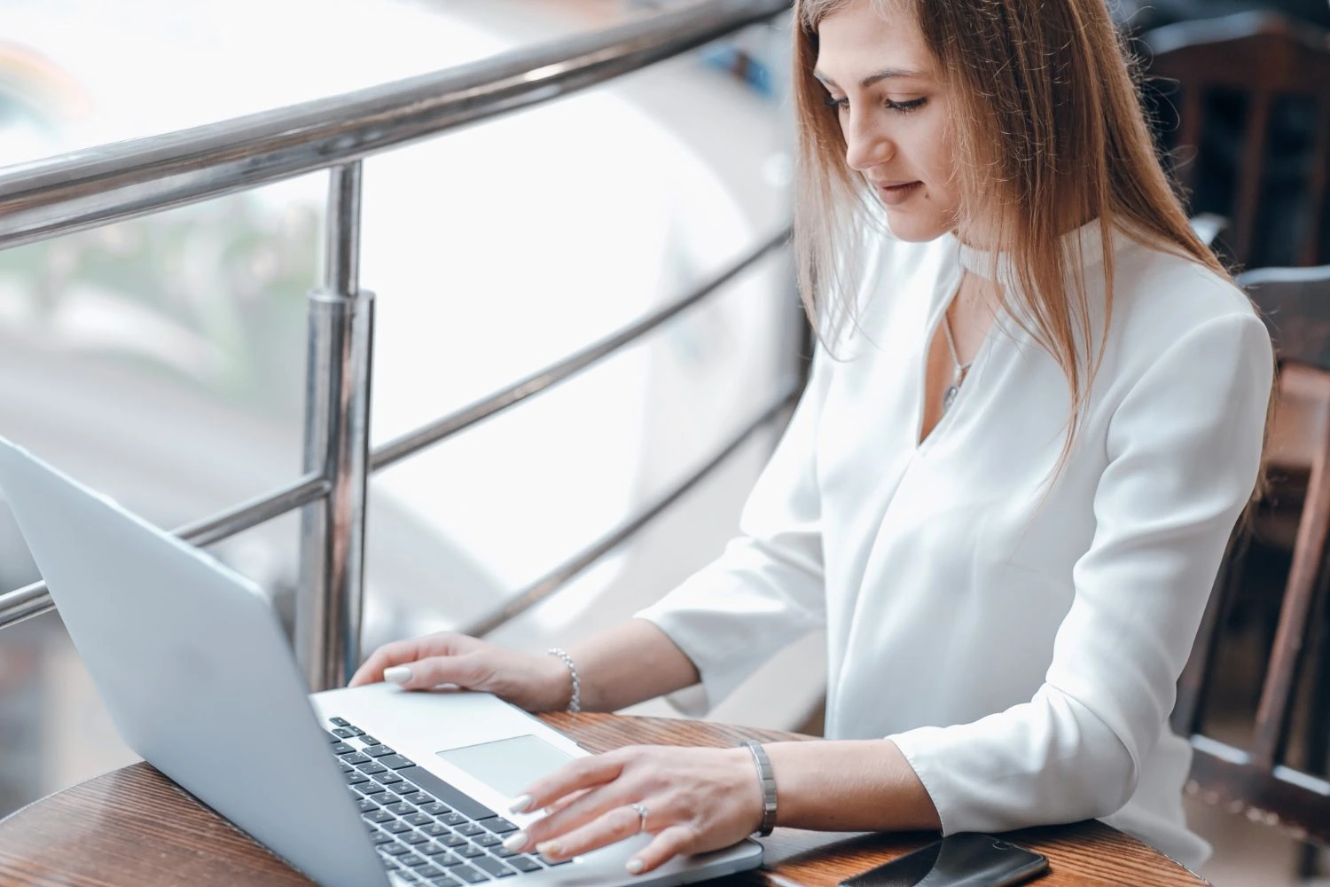 Enterprise woman typing fast using Summary AI on her work laptop.