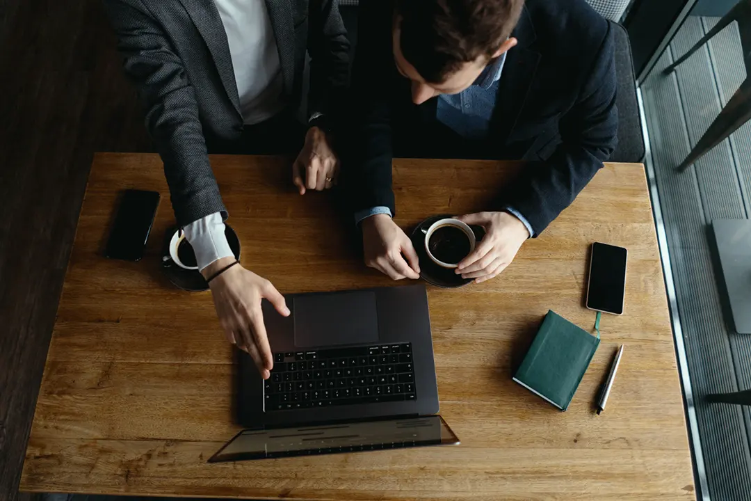 Two sales professionals reviewing Summary AI’s sales meeting notes template they use in their demos to find improvements.