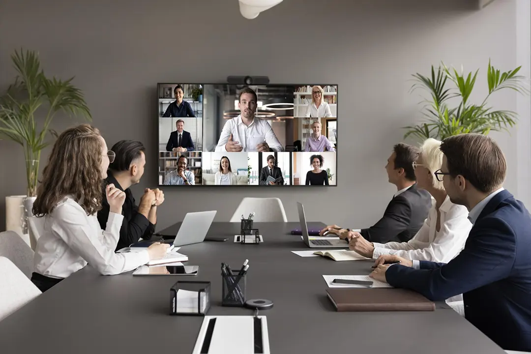 Leadership team from enterprise company doing a zoom meeting after downloading zoom video communications.
