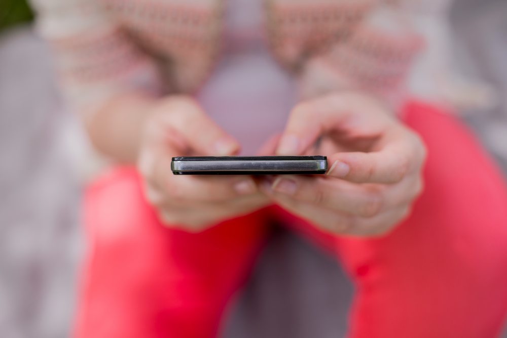 girl checking messages on phone