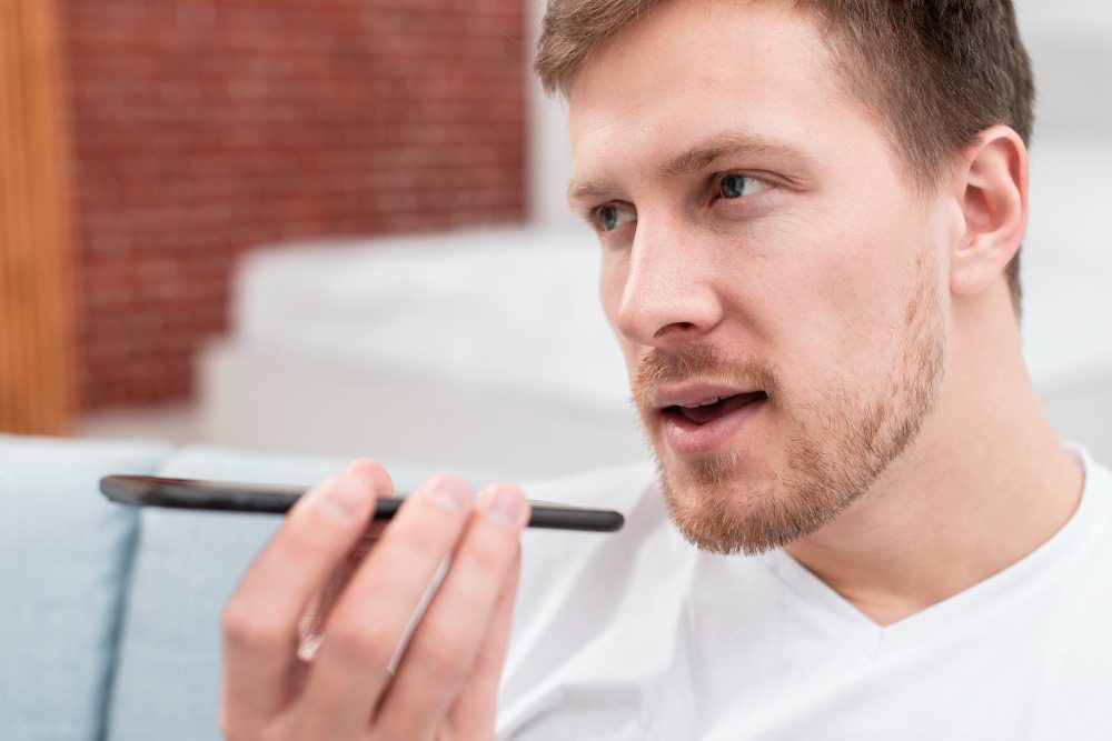 man speaking clearly into iphone during audio recording