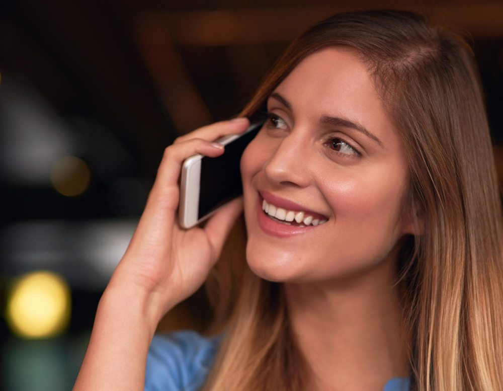 person listening to message on iphone