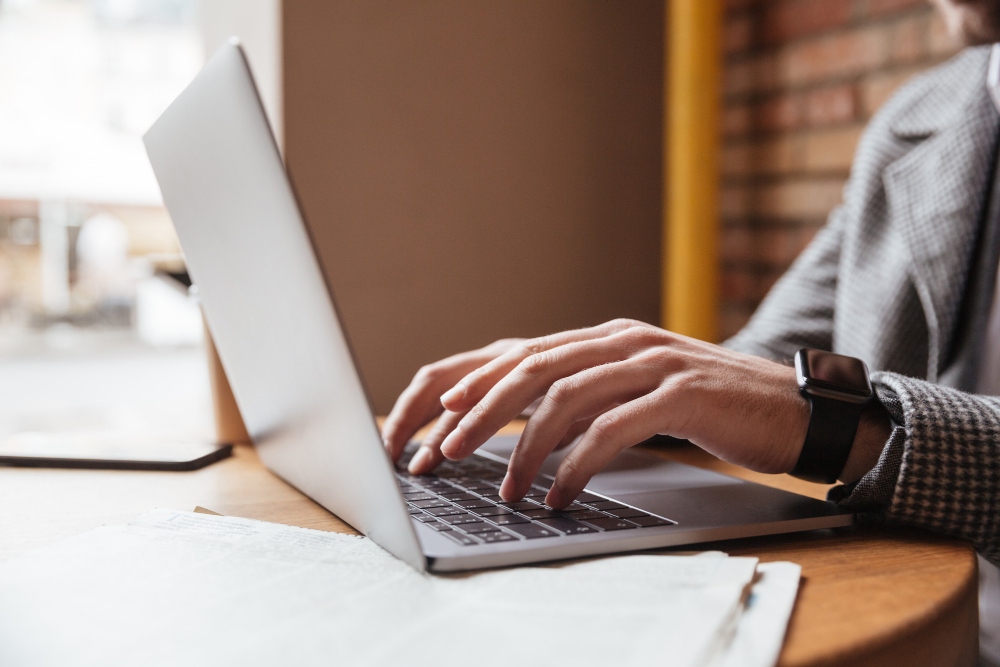 office worker typing on laptop