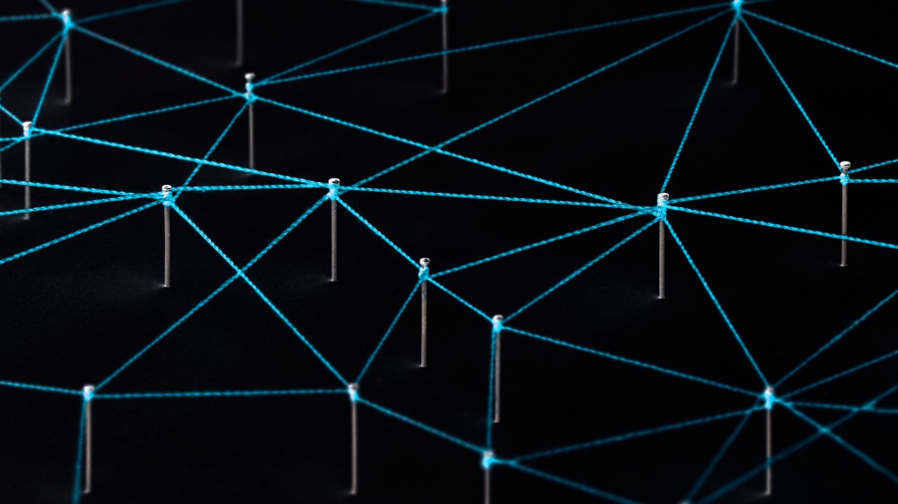 Pins and threads representing a neural network to teach how ai works