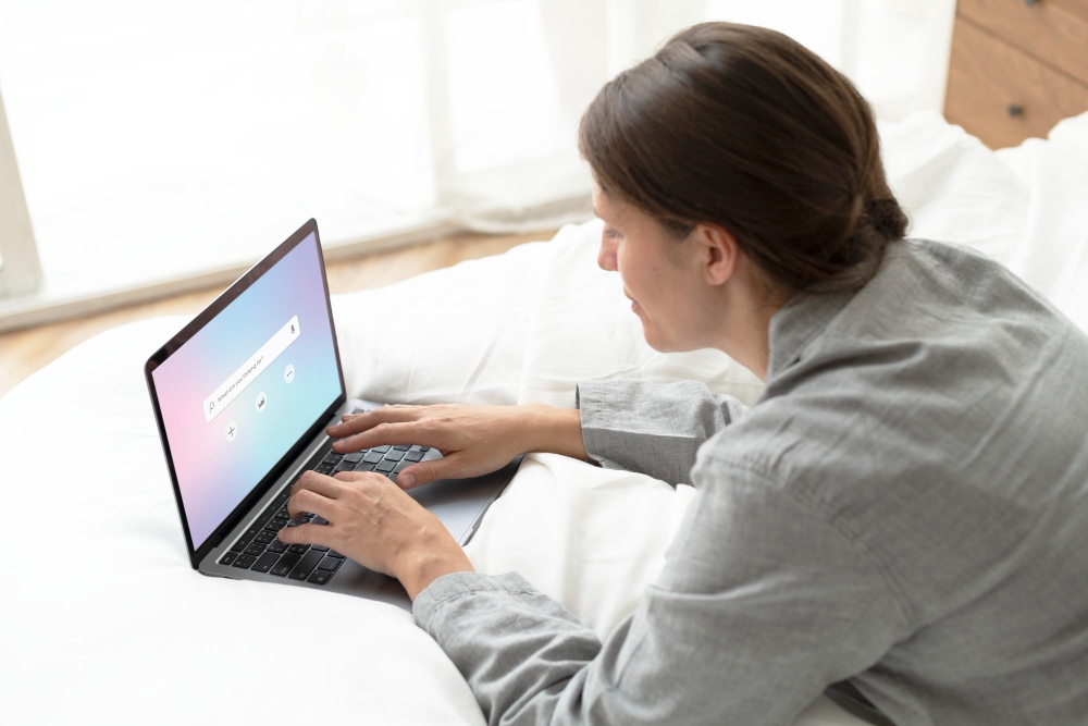 Person typing a prompt into an AI chatbot on a laptop screen