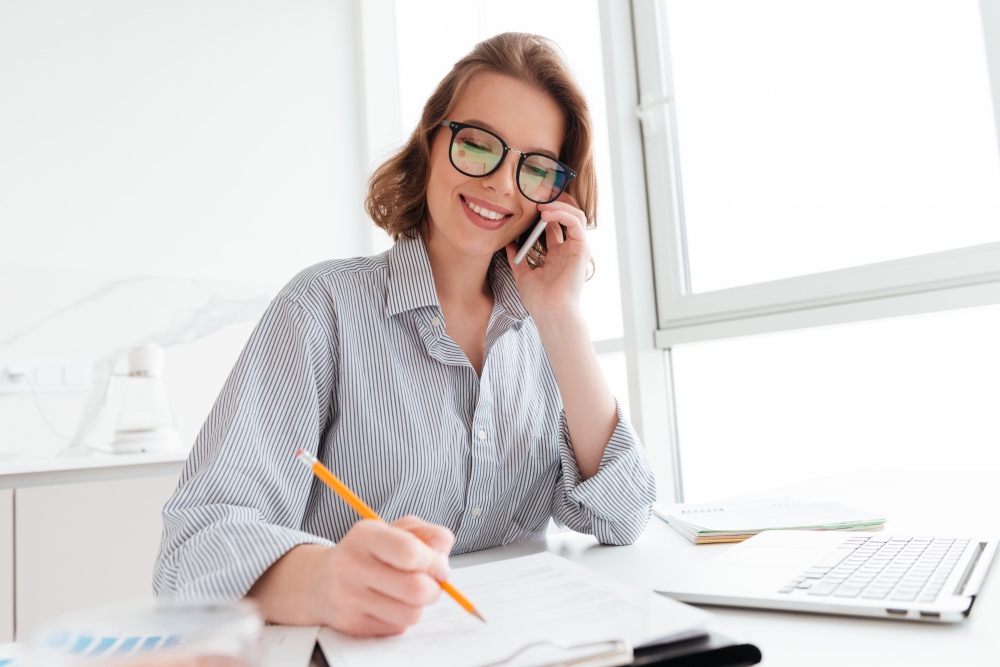Professional listening to a recorded phone call and taking notes 