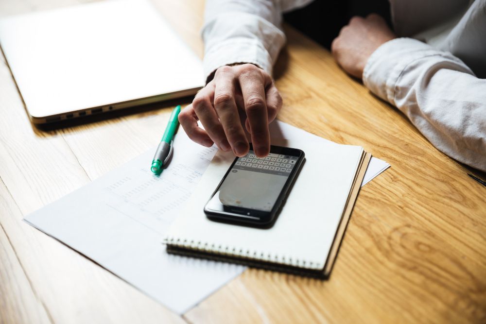 person taking notes on phone
