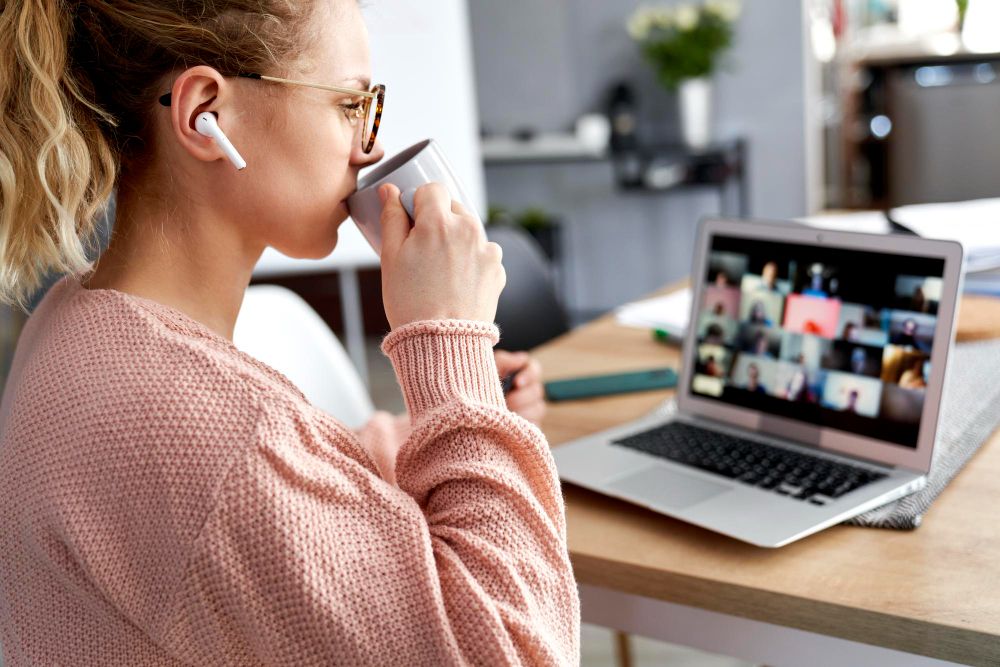 person using airpods in online meeting