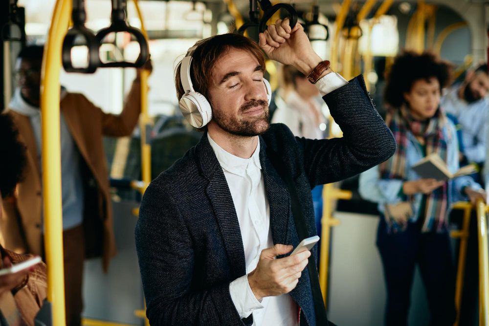 commuter using active noise cancellation earbuds