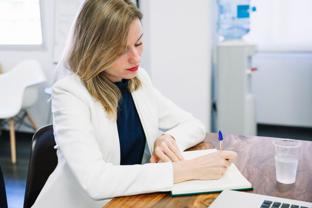 researcher taking notes during interview