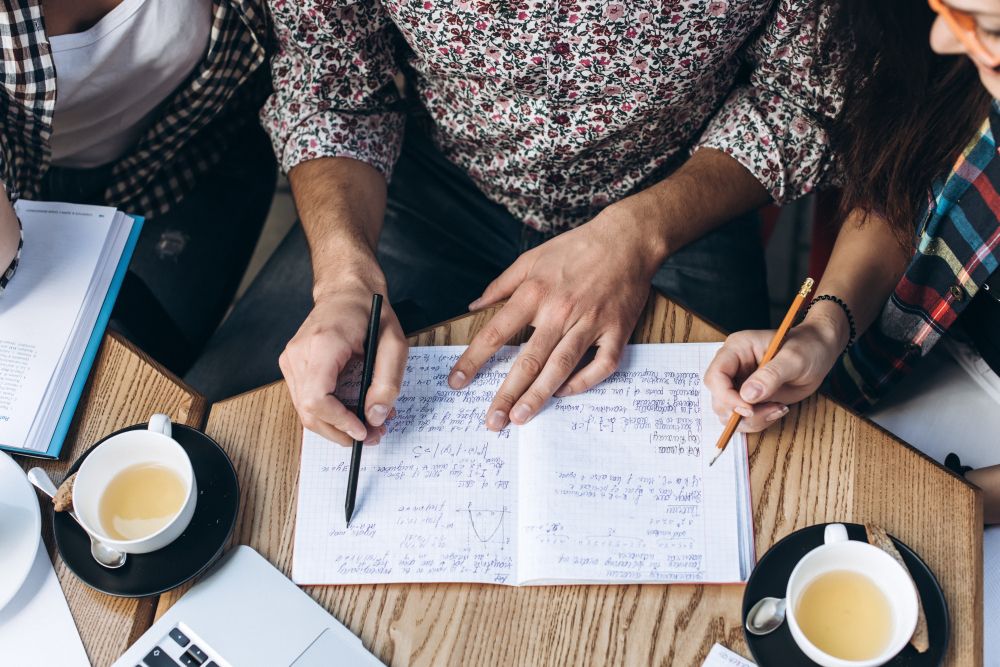 taking meeting notes in a notebook
