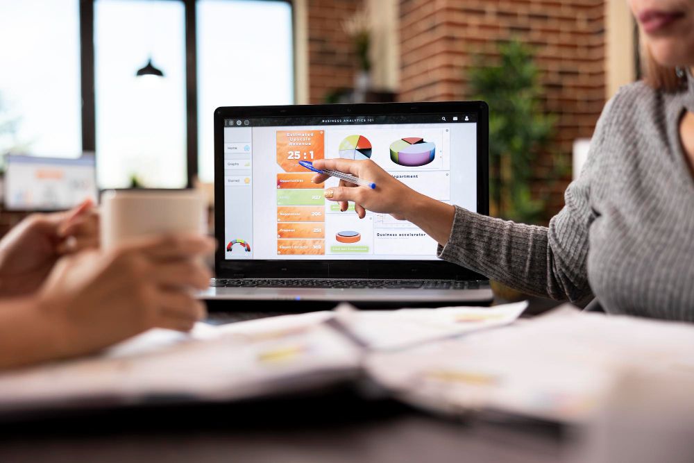 professional reviewing business analytics on laptop
