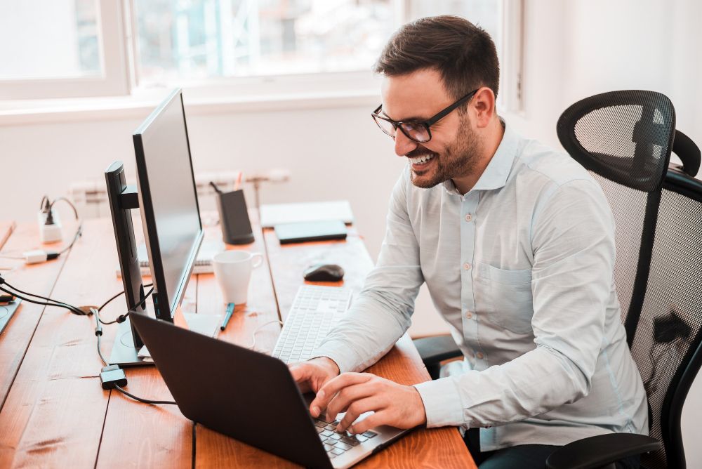 professional working with laptop and desktop monitors