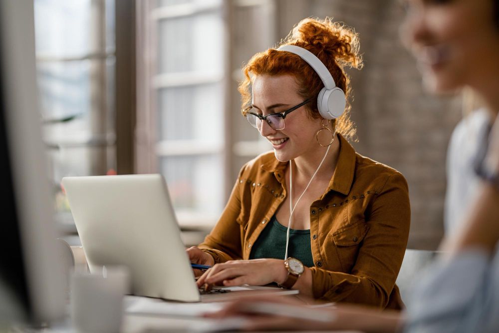 professional working with headphones and laptop