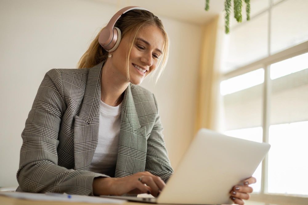 professional working on laptop with headphones