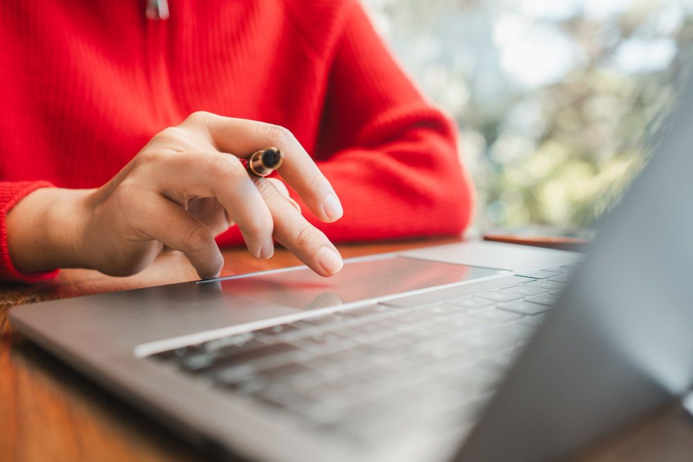 professional working with notes on a laptop