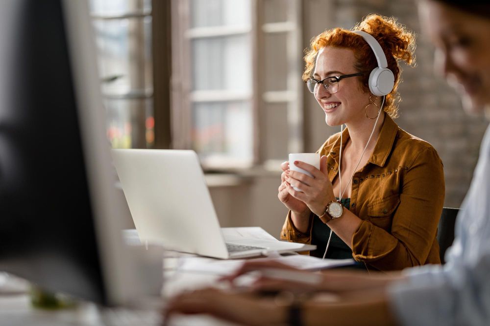 professional wearing headphones while working at a laptop