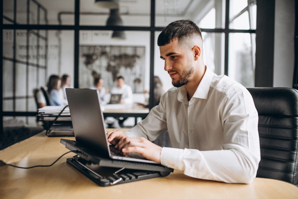 professional working on laptop in modern office