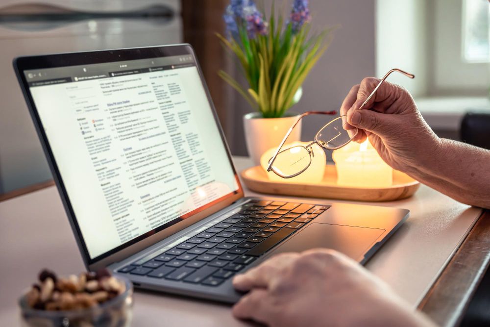 person reviewing research on a laptop