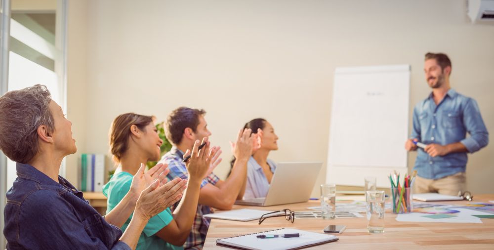 coworkers taking notes during a group discussion